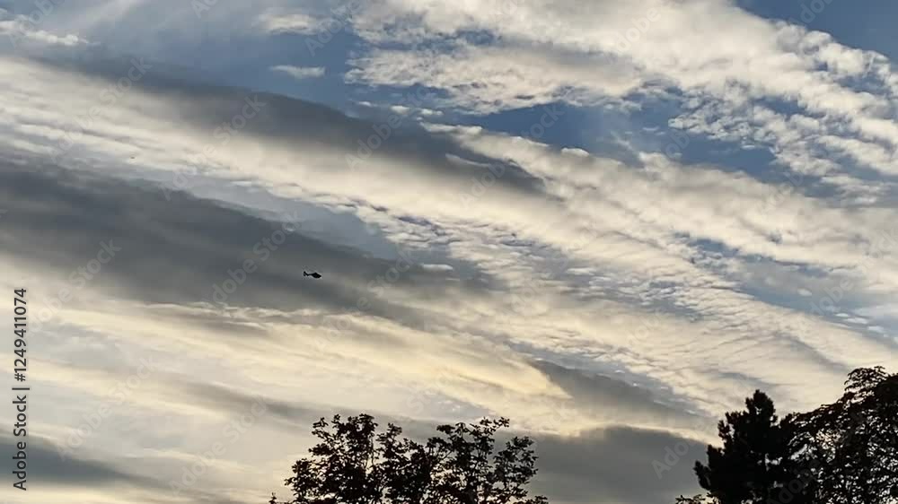 Poster cloudy sky with a drone flying in it. the sky is mostly gray with some white clouds scattered throug