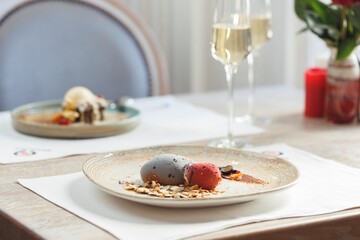 A beautifully arranged table features sushi delicacies alongside enticing desserts, highlighting fresh ingredients crafted by a renowned chef for a Valentine's Day treat