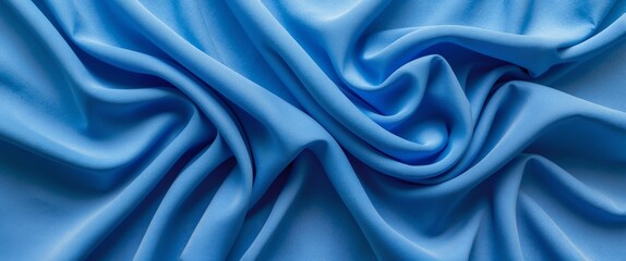 Obraz premium Vibrant blue fabric texture with elegant wrinkles and folds creating a dynamic visual flow suitable for design and textile backgrounds