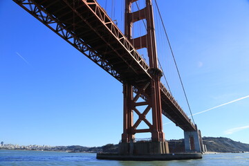 Golden Gate Bridge Close-Up with Steel Framework Against a Clear Blue Sky