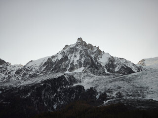 Snow covered mountain peaks gleaming under clear sky, revealing alpine landscape of chamonix and aosta during late autumn season