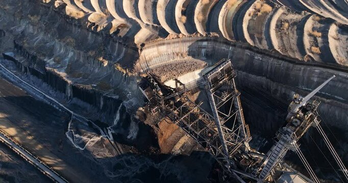 Lignite mine, bucket wheel mining machines excvating coals in large open pit mine in the german ruhr area.