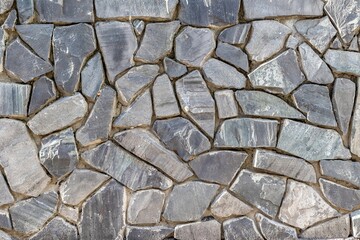 Close-up of irregular blue stone wall texture surface