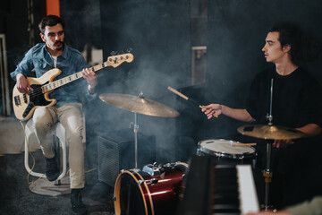 Fototapeta premium A band of musicians practicing and performing together on stage, creating lively music with drums, bass, and keyboards, fostering teamwork and creativity during a rehearsal session.
