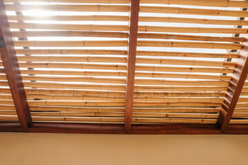 Bamboo pattern to prevent sun for Mediterranean shade,Bamboo mats on a roof,The walls are made of bamboo with sunlight,front view,copy space.