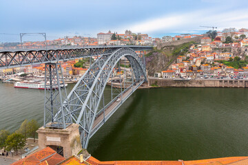 Steel bridge of Dom Luis I in Porto, view of the area with colorful houses, Portugal