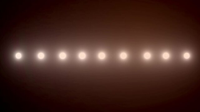 Flashes of spotlights of different shapes on the wall.