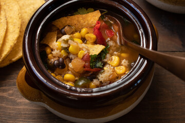 Vegan Mexican soup made with corn, pasta,black beans, green chiles. Served in clay pots