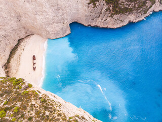 Navagio bay with shipwreck popular tourist attraction in beautiful turquoise Ionian sea on Zakynthos island, drone aerial view