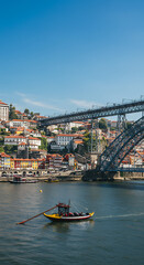 Obraz premium Porto's Charm: Douro River, Dom Lu?s I Bridge & Rabelo Boat Scene | Portugal's Iconic Cityscape