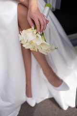 bride with a wedding bouquet of white flowers