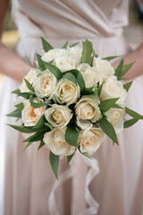bride with a wedding bouquet of white flowers