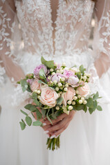 hands of the bride with a wedding bouquet