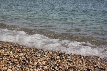 Water flowing among the rocks on the beach.