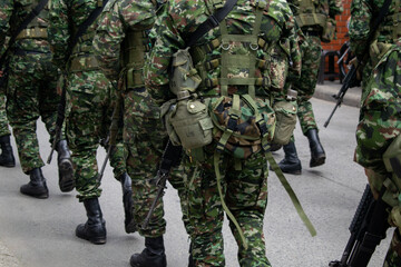 Colombian army patrolling the streets, military forces on urban patrol in Colombia, soldiers securing the streets in Colombia, army troops conducting street patrol, Colombian military presence in