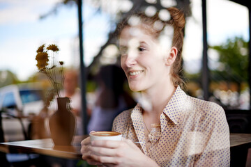 Fototapeta premium Coffee, window and woman in cafe in morning with creative digital nomad career. Planning, ideas and female freelance copywriter drinking cappuccino on break at restaurant with confidence and pride.