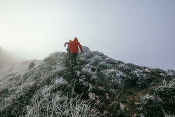 Fototapeta premium Trail running couple man and woman running on a mountain path