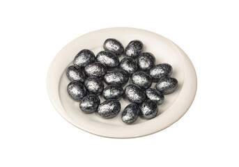 Silver color dragee in white plate isolated on a white background. Close up shot. Ramadan candy concept idea