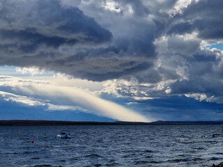 Dramatic storm clouds over the sea with sun rays breaking through