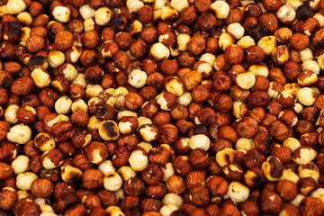 peeled hazelnuts are fried in a frying pan