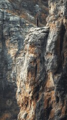 Man standing on a rocky cliff overlooking a mountain range