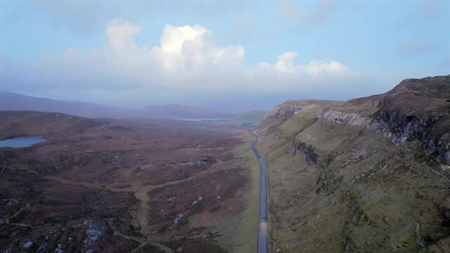The A835, part of the North Coast 500 touring route passing through Knockan Crag Nature Reserve, Sutherland, Highlands, Scotland, United Kingdom