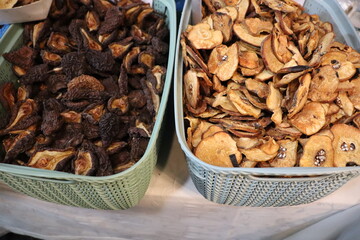 Colorful Dried Fruits and Savory Mushrooms Beautifully Arranged in Baskets at the Market