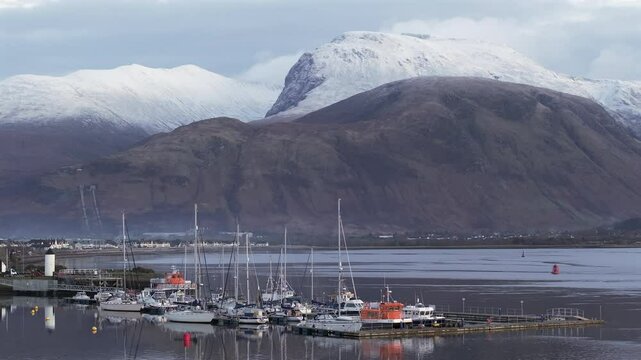 Corpach lighthouse and marina on the shores of Loch Eli with snow capped Ben Nevis and Fort William, Highland region, Scotland, United Kingdom 