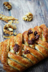 Braided Pastry with Walnuts on Wooden Surface