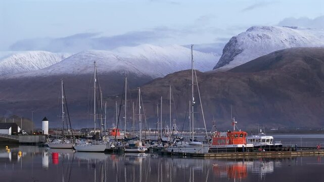Corpach lighthouse and marina on the shores of Loch Eli with snow capped Ben Nevis and Fort William, Highland region, Scotland, United Kingdom 