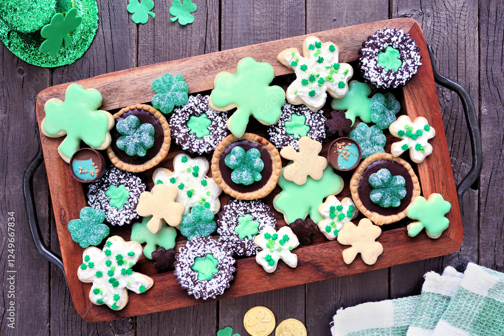 Poster st patricks day shamrock dessert board. green cookies and sweets. overhead view table scene on a rus