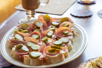 Snacks on the table. Canapes, cake, coffee on the table in the room