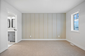 White bedroom with a white wall and a white door