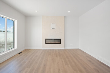 Large room with a fireplace and a window