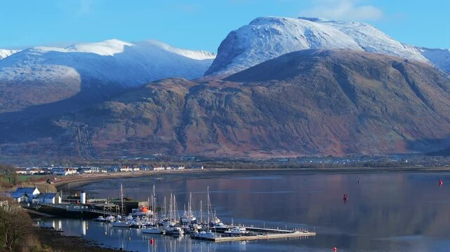 Corpach lighthouse and marina on the shores of Loch Eli with snow capped Ben Nevis and Fort William, Highland region, Scotland, United Kingdom 
