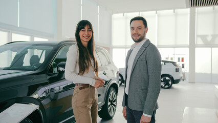People talking while making important decision about vehicle purchase. Husband and wife discussing...