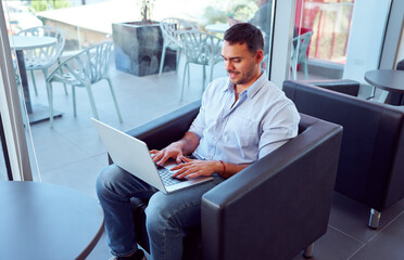 Young professional working on laptop in modern office