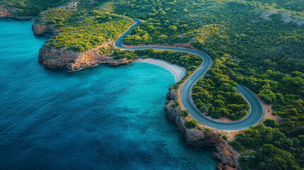 Aerial view of a winding asphalt road along a dramatic coastline, symbolizing the journey through uncertainty and change. Modern blurred background with empty space for captions, evoking a sense of ch