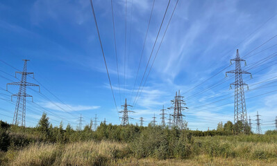 Big Electric power lines close up against blue sky.