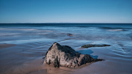 The image captures a serene, ethereal seascape bathed in a soft, dreamy light. Smooth, flowing...
