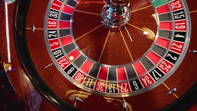the ball has stopped at number 23 and is spinning on the roulette wheel in the casino