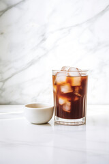 A Glass of Iced Black Coffee Next To A White Espresso Cup On White Marble Surface. Natural Light and Shadow, Minimal Coffee Shop Interior. 