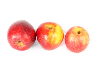 Three red apples on a white background