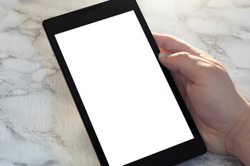 Hand holding tablet with blank screen on light background. Digital reader in foreground with space to customize content. Blank space ideal for design or text.
