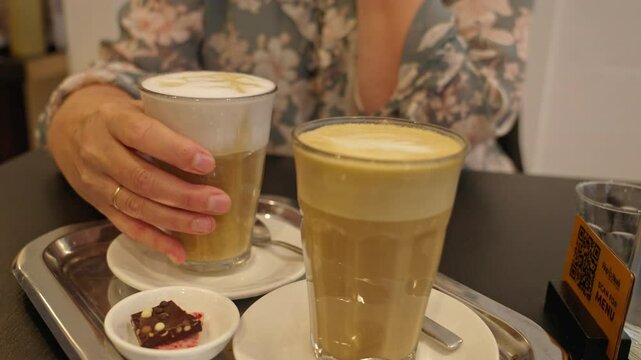 Enjoying latte coffee drinks at a cozy cafe during a relaxing afternoon