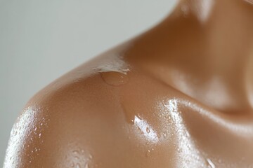 Fototapeta premium A detailed close-up of the skin on woman's shoulder. small cream on her shoulder