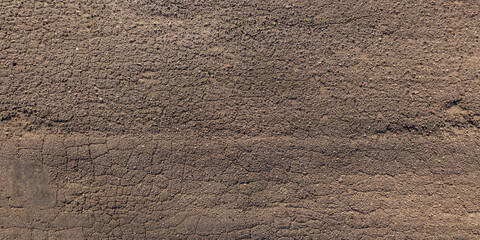 view from above on texture of old asphalt road with cracks