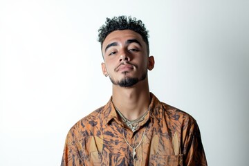 Obraz premium Confident Young Man with Curly Hair in a Stylish Shirt Against a Plain Background