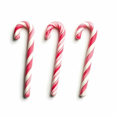 Three candy canes on white background; holiday sweets