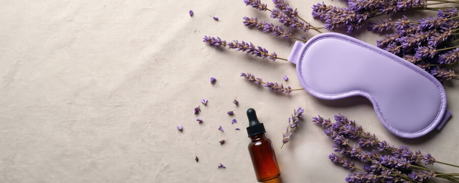 Lavender sleep mask, aromatherapy oil on light beige textile background. Natural sleep aid concept. Healthy sleep accessories. Relaxing, calming atmosphere. Zero waste products for better night rest.